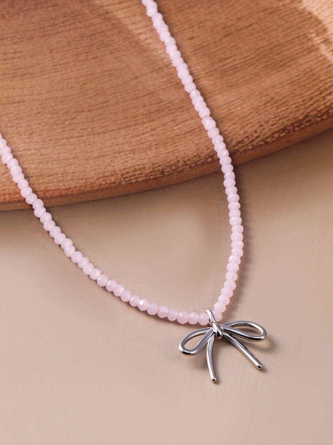 rhodium-plated-soft-pink-beaded-necklace-with-silver-bow-pendant-necklace-and-chains-36954407010478.jpg